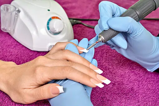 removing-acrylic-nails-with-nail-drill-by-a-manicurist
